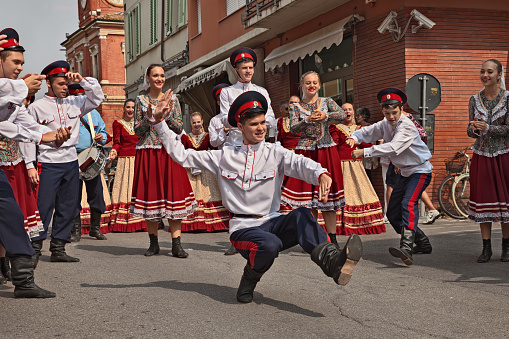 the folk dance ensemble Rejoice the Russians from Azov, Russia, performs traditional Cossack dance in the city street during the International Folklore Festival in Russi, Ravenna, Italy - August 2, 2018