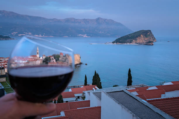 istock Glass with red wine above Budva 1126781643