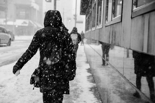 people walking on snow in toronto's street