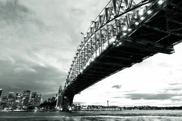 istock Black and white Harbour Bridge with city skyline at night 1126782095