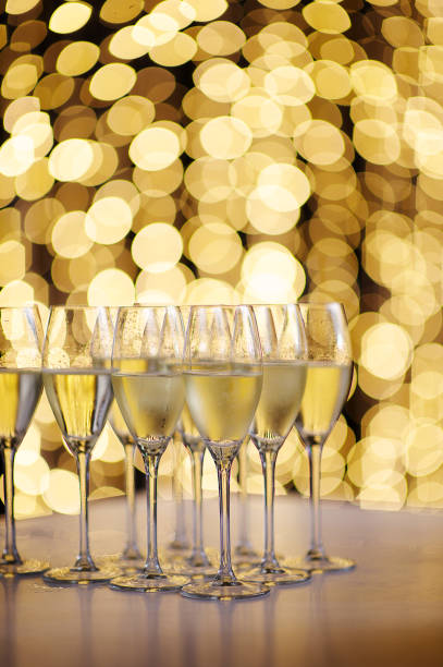 istock Champagne glasses with fairy string lights backdrop 1126784524
