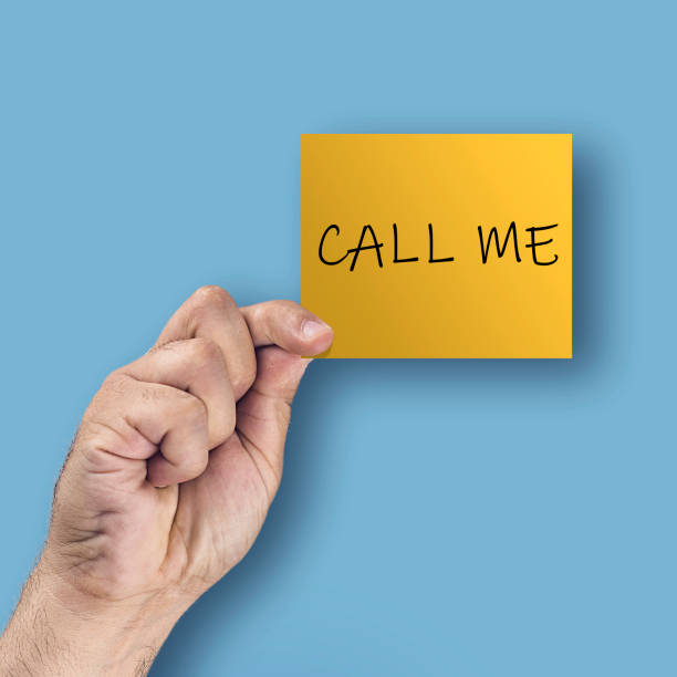 istock Call me. Hand showing or holding card with text 1126785146