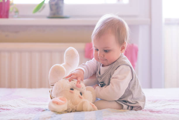 istock Baby playing with a plush toy 1126788146