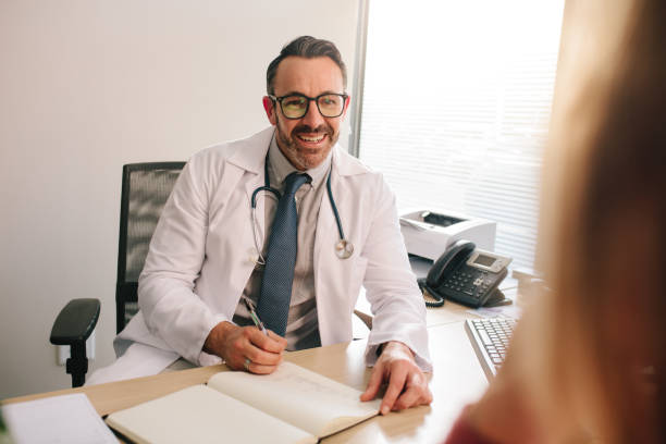 istock Doctor talking with patient in his clinic 1126788423