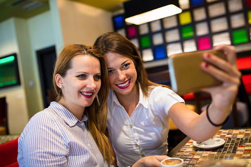 Women make selfie in Cafe