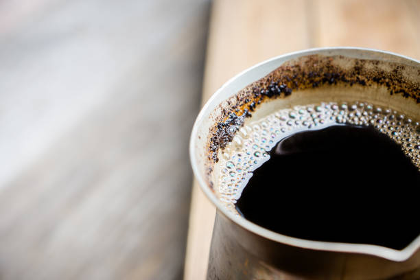 istock Coffee pot with hot coffee on the wooden table 1126795729
