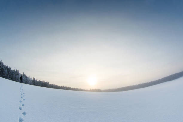 istock Winter landscape with a man on the snow field and steps 1126797201