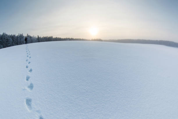 istock Winter landscape with a man on the snow field and steps 1126797202