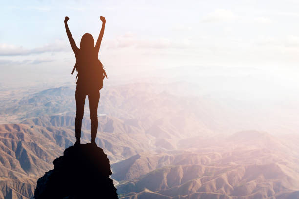 istock Woman Silhouette at sunset on hill 1126797602