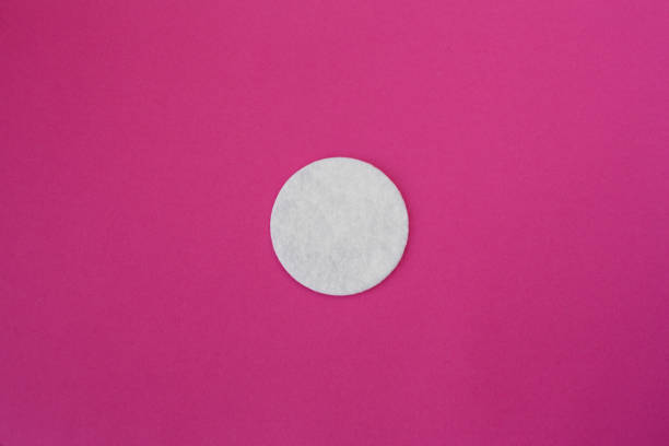istock top view on white round cotton disks laid out on a pink background 1126797798