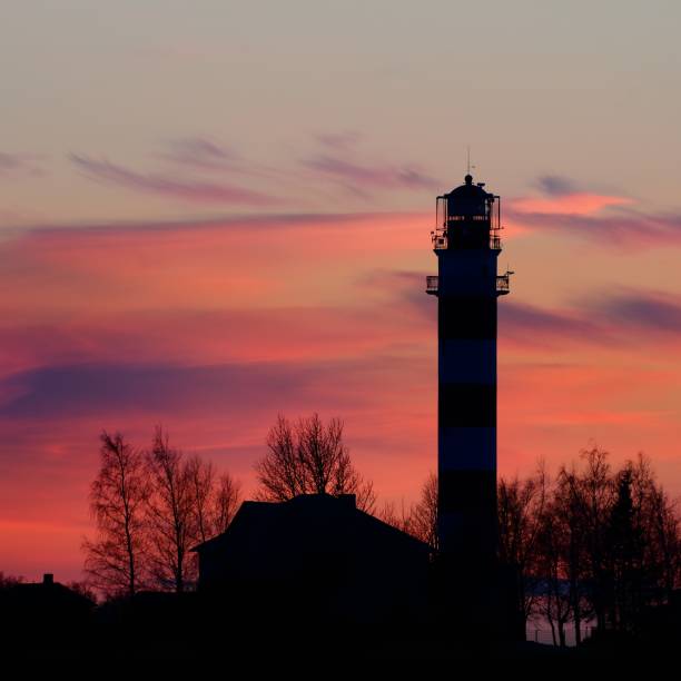istock lighthouse in the sea at the colorful sunset 1126799579