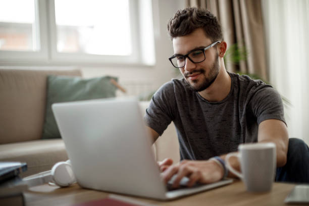 istock Young man using social media at home 1126799745