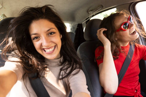 istock Two happy young women having fun in car 1126804126