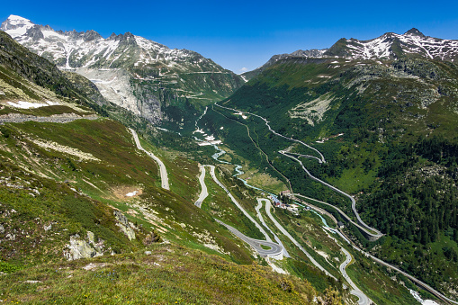 Alpine landscape of Upper Valais: on the foreground the road to Grimsel Pass, on the background the road to Furka Pass, at the bottom of the valley the Rhone River, Valais, Switzerland