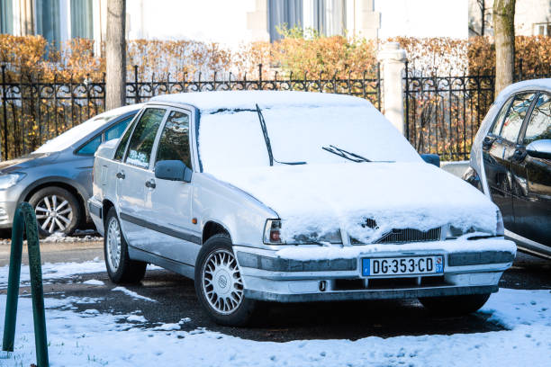 Cold weather snow and vintage Volvo 740 Strasbourg, France - Dec 18, 2018: Vintage Volvo 740 limousine car parked on French street in the winter volvo 740 stock pictures, royalty-free photos & images