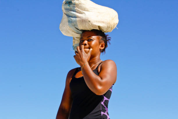 istock Malagasy woman carrying cargo on head 1126808926