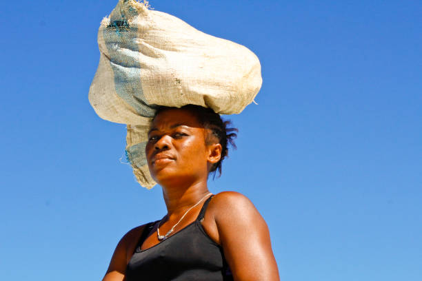 istock Malagasy woman carrying cargo on head 1126808936