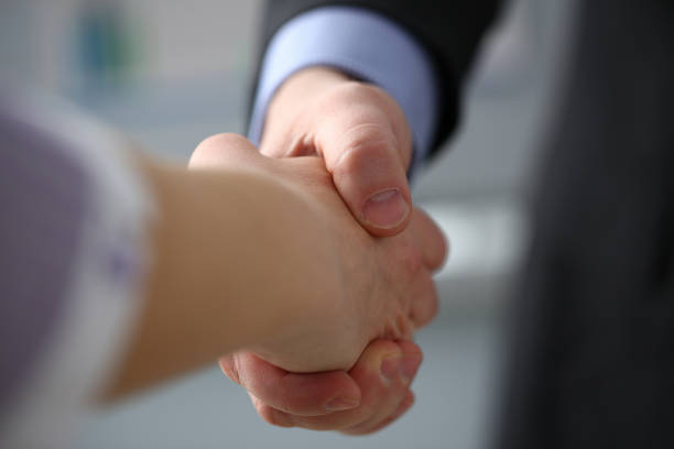 istock Man in suit and tie give hand as hello in office 1126808987