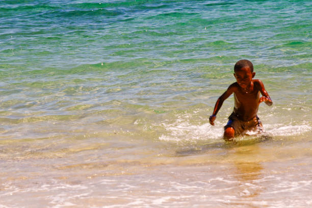 istock Poor malagasy boy playing on the beach 1126809460