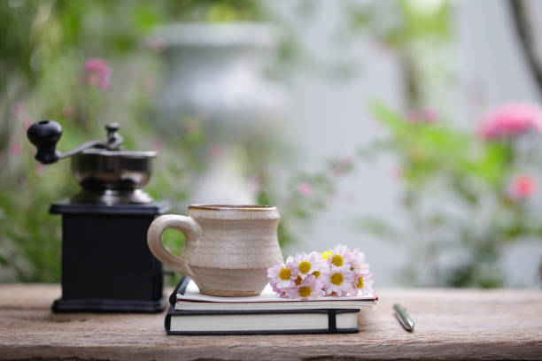 istock Pink cosmos flower with cup and  notebooks on wooden table 1126809522
