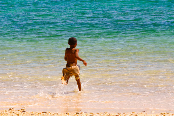 istock Poor malagasy boy playing on the beach 1126809776