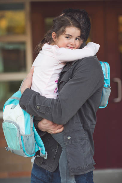 istock Dad drops little girl off at school 1126809810