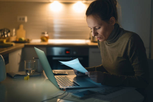 istock Young woman going through home finances 1126810182