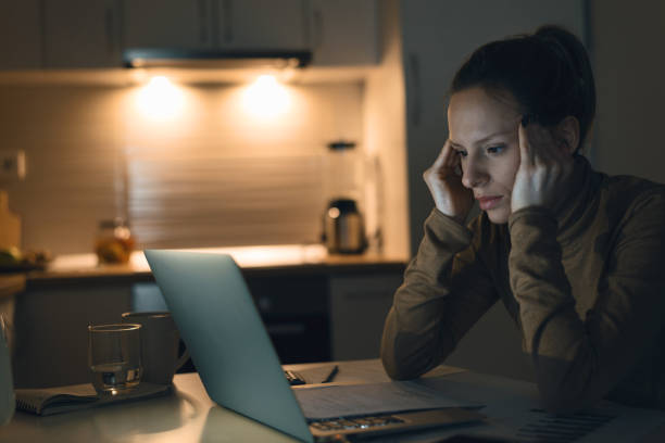 istock Young worried woman going through her home finances 1126811122
