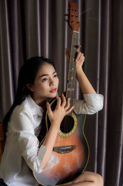istock Women guitar wood 1126811155