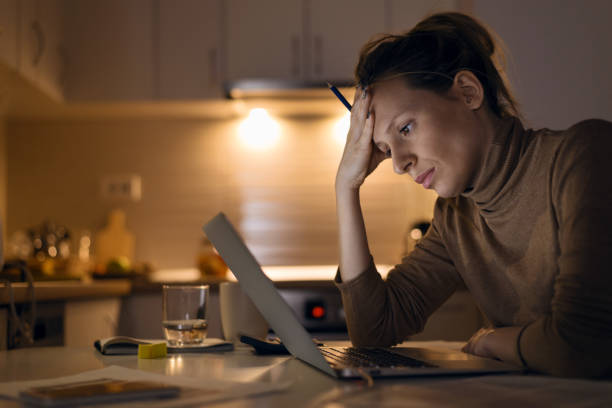 istock Stressed woman working on her monthly finances at home. 1126811201