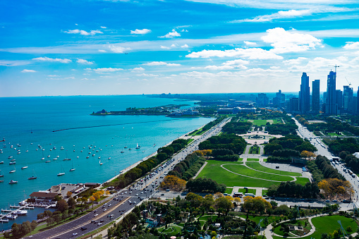 An aerial view of Grant Park, Lake Shore Drive, Lake Michigan and buildings in Chicago