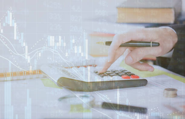 istock digital financial background. Hand touch calculator and calculation 1126813311