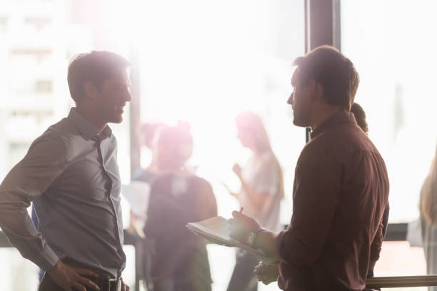 istock Businessmen discussing in brightly lit office 1126818623