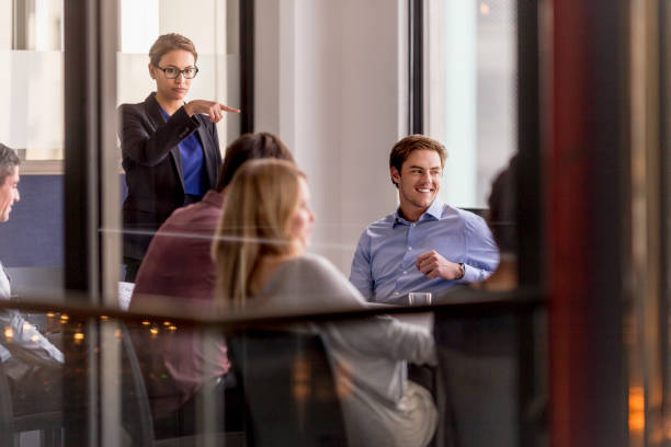 istock Businesswoman pointing at executive during meeting 1126818645