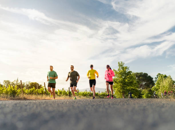 istock Joggers running on road against sky 1126818716
