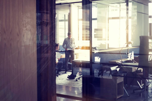 Business people talking in brightly lit board room