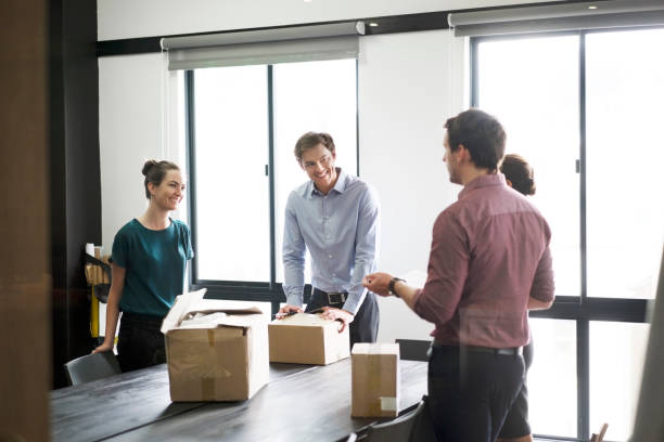 istock Happy business colleagues packing boxes at office 1126820237