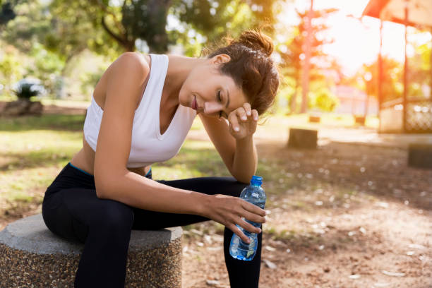 istock Exhausted female athlete wiping sweat at park 1126820925