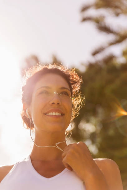 istock Thoughtful athlete listening music on sunny day 1126821113