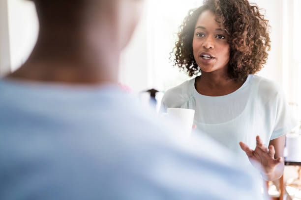 istock Woman talking to man at home 1126821877