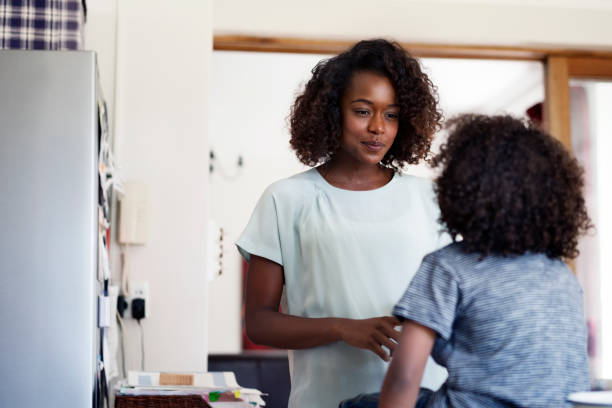 istock Young woman talking to son at home 1126822020