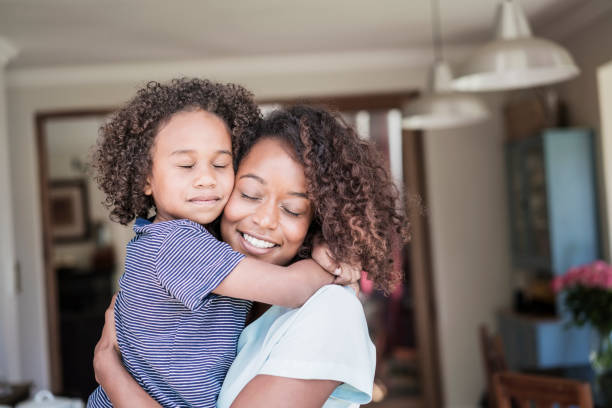 istock Loving mother and boy embracing at home 1126822720