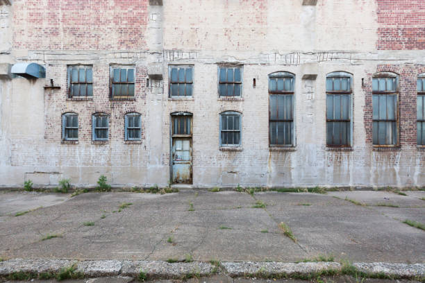 Facade of abandoned building with windows and door, in Davenport, Iowa, USA Facade of an abandoned building with windows and door, in Davenport, Iowa, USA davenport iowa stock pictures, royalty-free photos & images