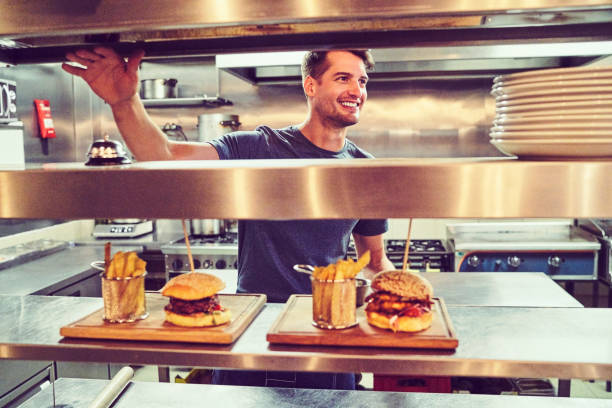 istock Happy chef with prepared orders waiting at counter 1126825944