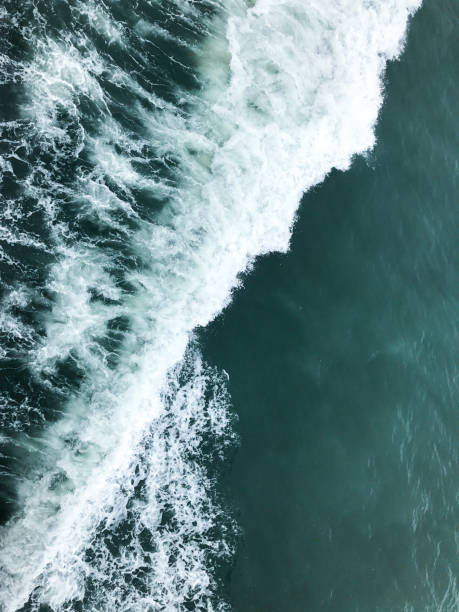 istock Deep blue stormy sea water surface with white foam and waves 1126826199