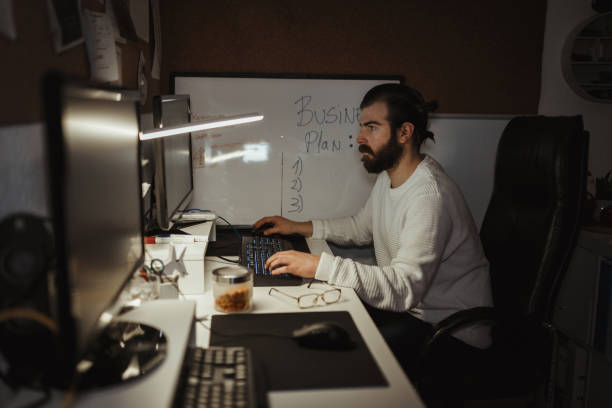 istock Young male millennial working late at home 1126827673