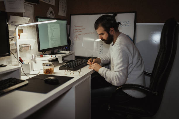 istock Young male millennial working late at home 1126827690