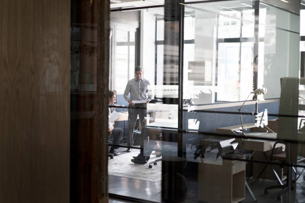 istock Business people discussing in brightly lit office 1126829782