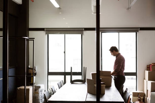 istock Male executive packing cardboard boxes at office 1126830011