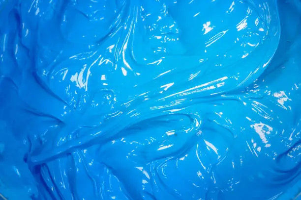 Photo of close up light blue color of oil paint.